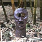 Photo of sculpture of face with one square eye
