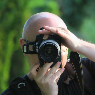 Headshot of photographer Max Cavitch, camera obscuring his face