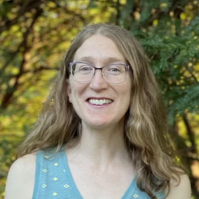 Headshot of author Ceridwen Hall in a blue tank top