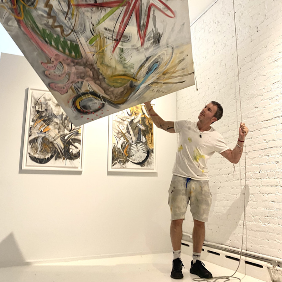 Headshot of Antonio Muñiz with a painting.