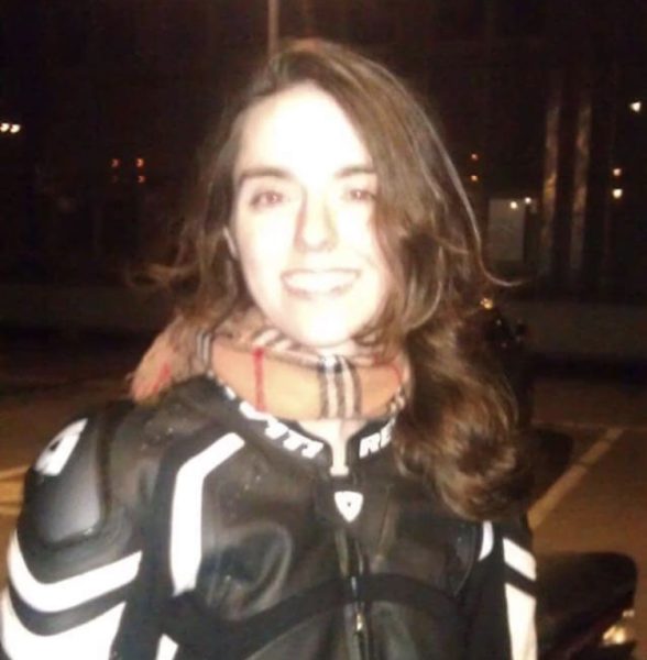 Photo of managing editor Paris Baldante smiling in a motorcycle jacket.