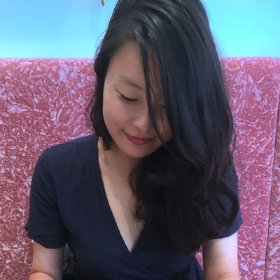 Jihyun Yun in black t-shirt against pink background