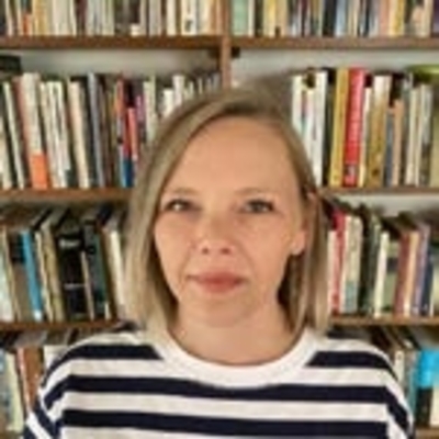 Clare Banks in front of bookshelf