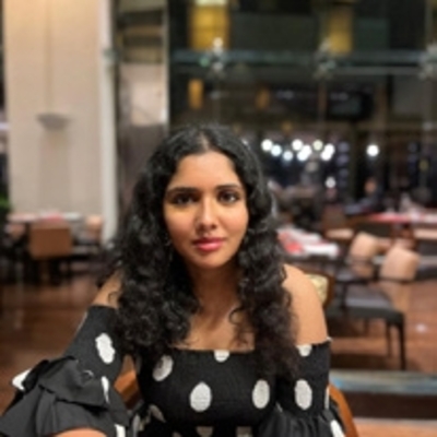 Deya Bhattacharya sitting at restaurant