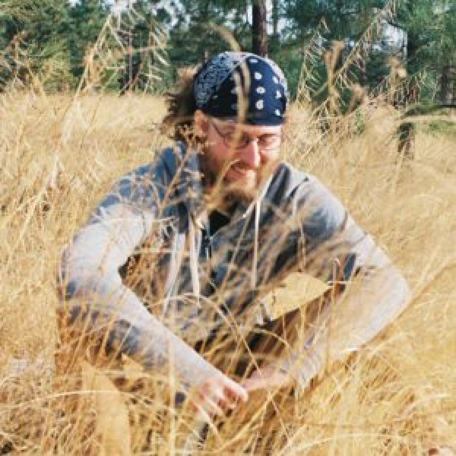 Picture of Mitch Marty sitting in a field.