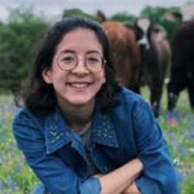 Emma Wu in front of cows